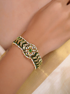 Samragni green meena kundan pearl bracelet shown flat with white stones, green accents and pearl border