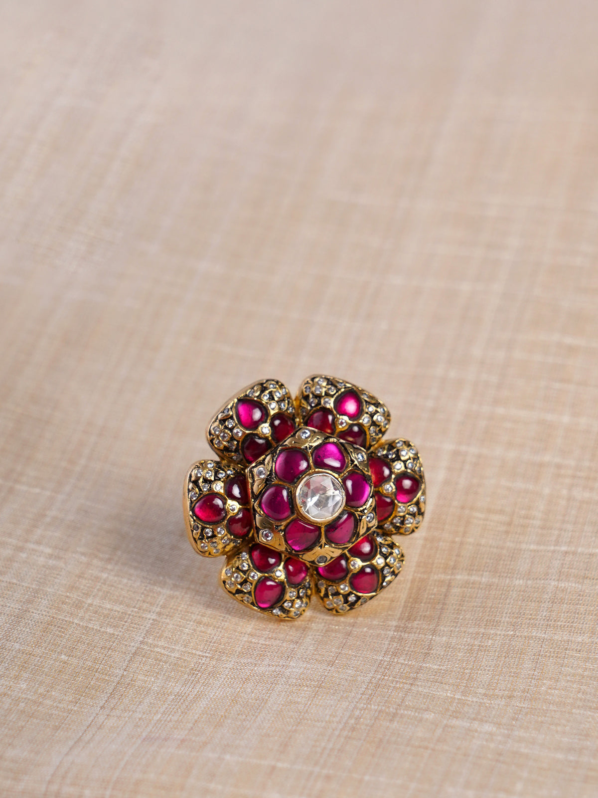 Samragni ruby bloom kundan jadau floral statement ring shown on hand with layered red petals and white stone centre