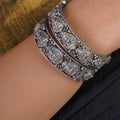 Sitavan Lakshmi temple oxidised silver bangle pair with deity relief motifs and coloured stone accents by Sita Jewellery