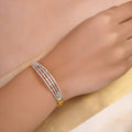SITAMANI triple-line baguette AD/CZ bangle in gold tone with clear stones by SITA JEWELRY