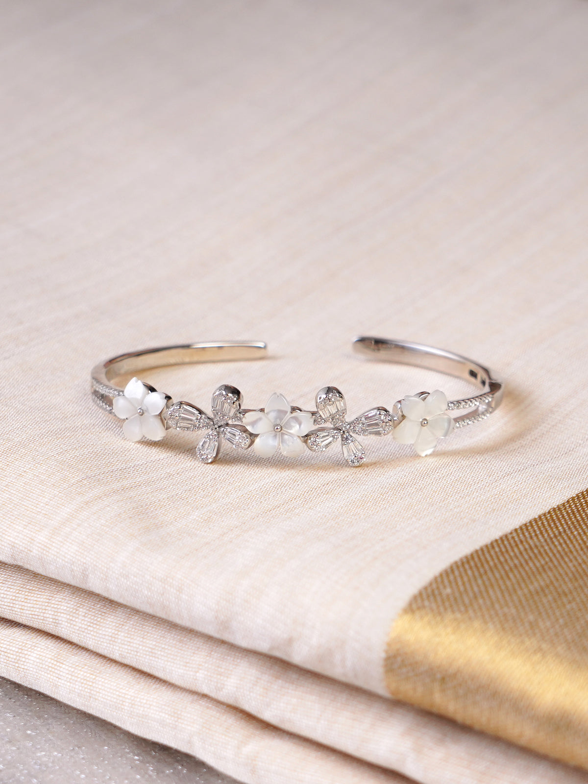 SITAMANI white floral butterfly AD/CZ cuff bracelet styled on wrist by SITA JEWELRY