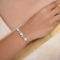 SITAMANI white blossom and butterfly AD/CZ cuff in silver tone with floral accents by SITA JEWELRY