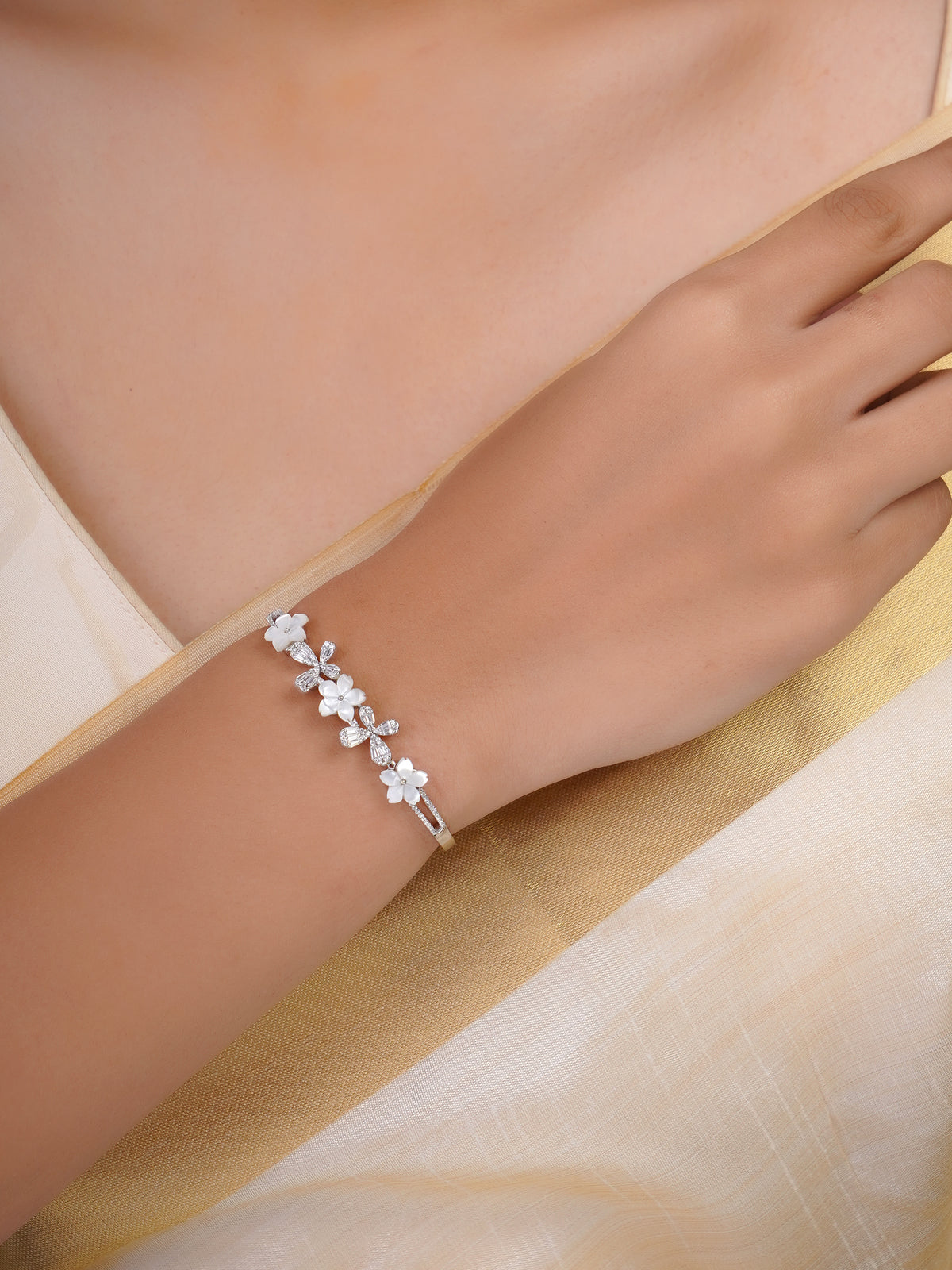 SITAMANI white blossom and butterfly AD/CZ cuff in silver tone with floral accents by SITA JEWELRY