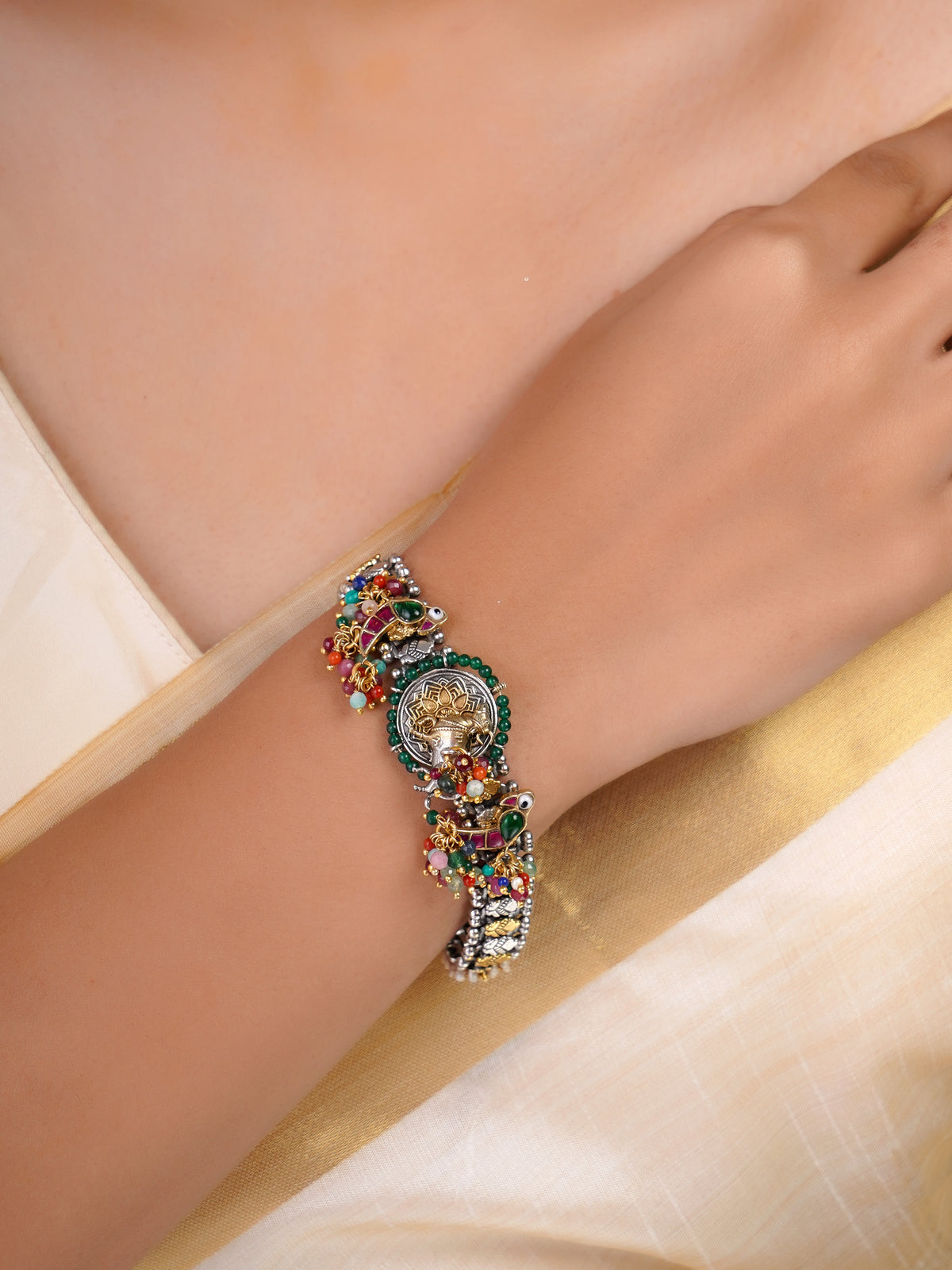 Sitamohur multicolour fusion bracelet shown flat with animal-inspired medallion, pearl accents and vibrant bead clusters