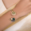 Sitamahor peacock green stone dual-tone fusion cuff shown on a cream textile background