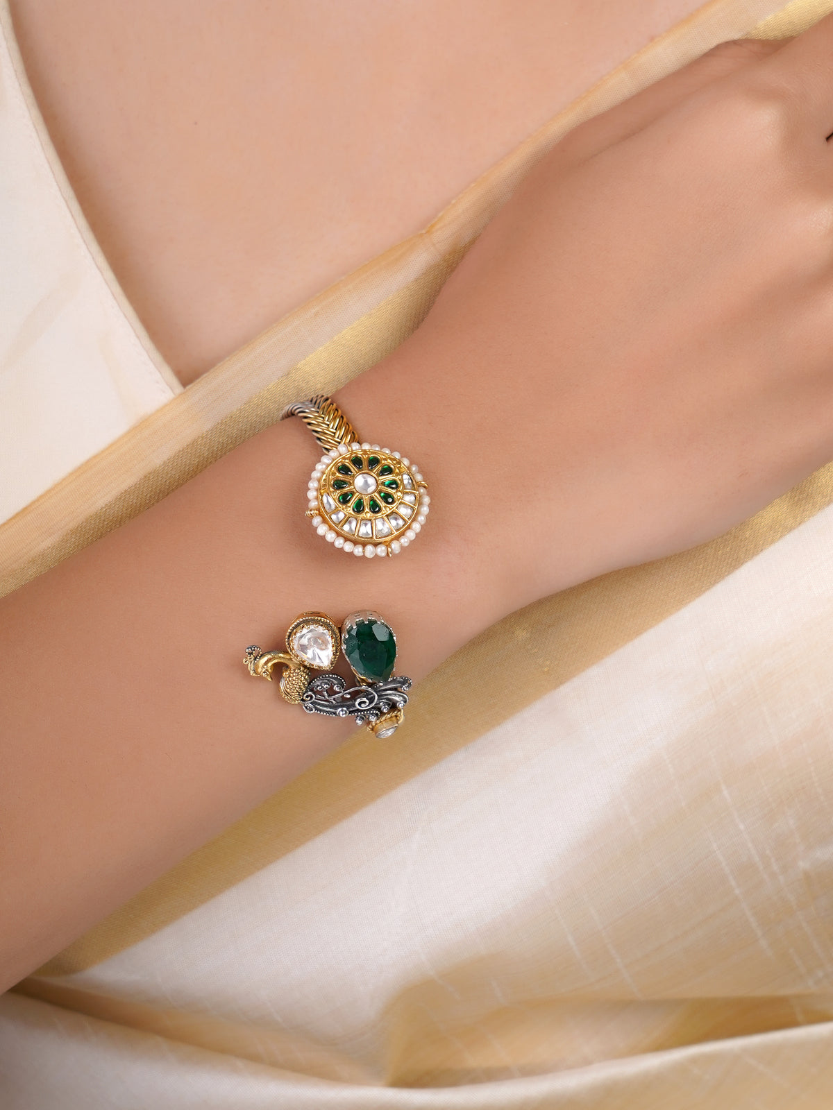 Sitamahor peacock green stone dual-tone fusion cuff shown on a cream textile background