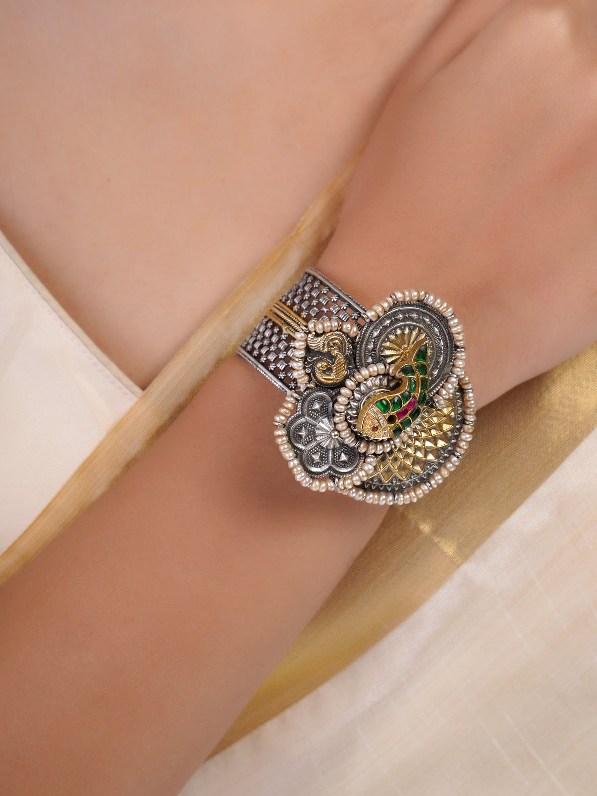 Sitamahor peacock pearl medallion fusion bracelet styled on the wrist with mixed silver and gold-tone detailing