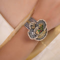 Sitamohur peacock pearl medallion fusion bracelet styled on the wrist with mixed silver and gold-tone detailing