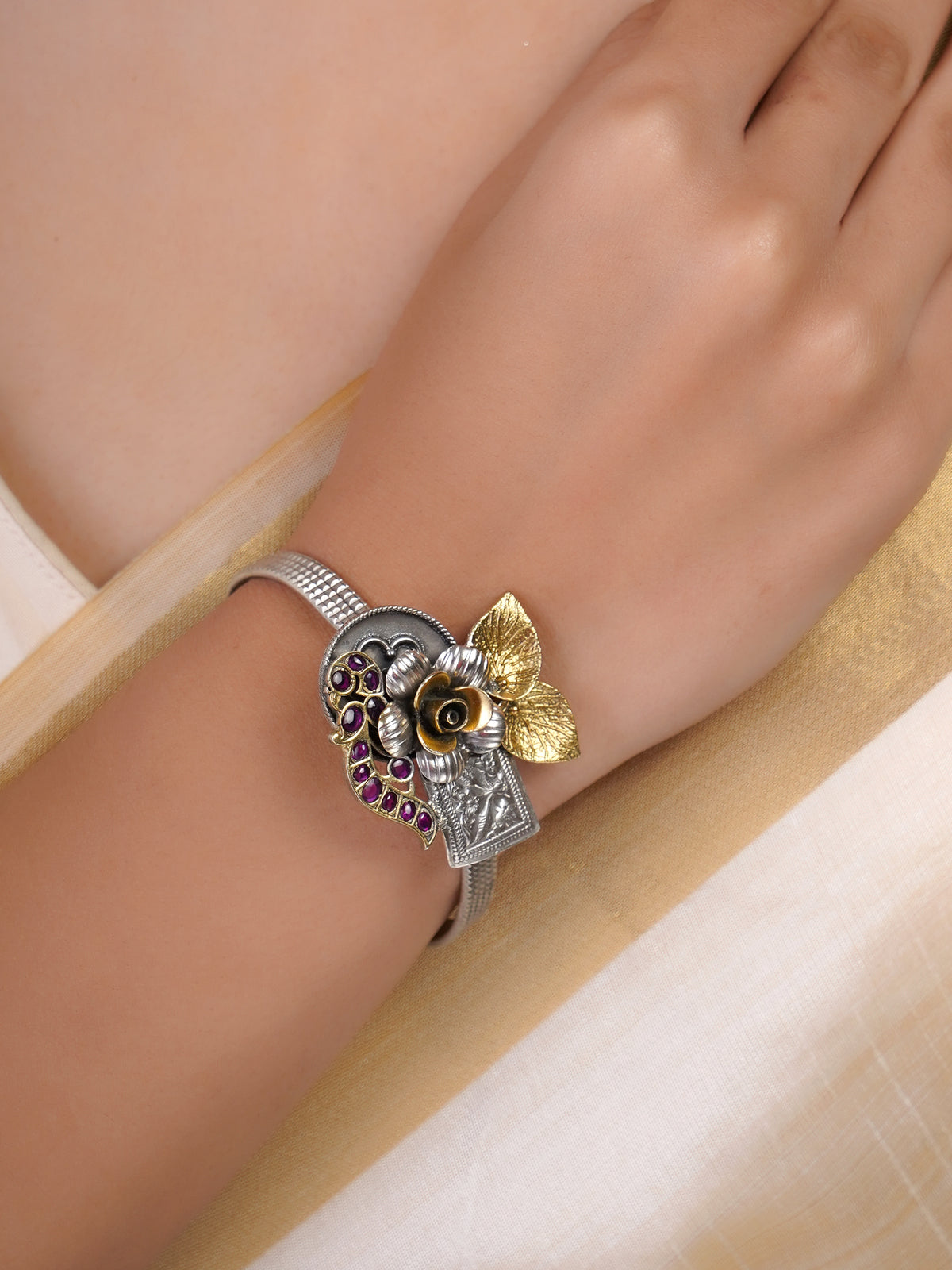 Sitamohur ruby floral paisley fusion bracelet styled on the wrist with sculpted mixed-metal detailing
