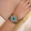 Samragni green kundan filigree statement cuff shown front-facing with large green centre stone and clear stone halo
