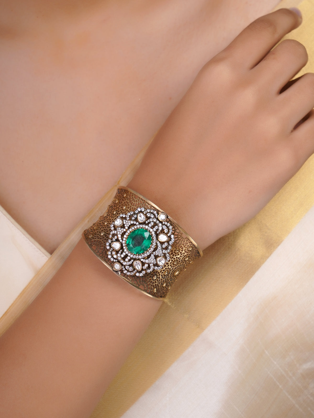 Samragni green kundan filigree statement cuff shown front-facing with large green centre stone and clear stone halo
