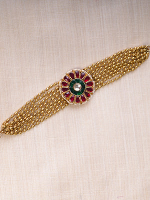 Samraagni red and green floral kundan bead bracelet styled on the wrist