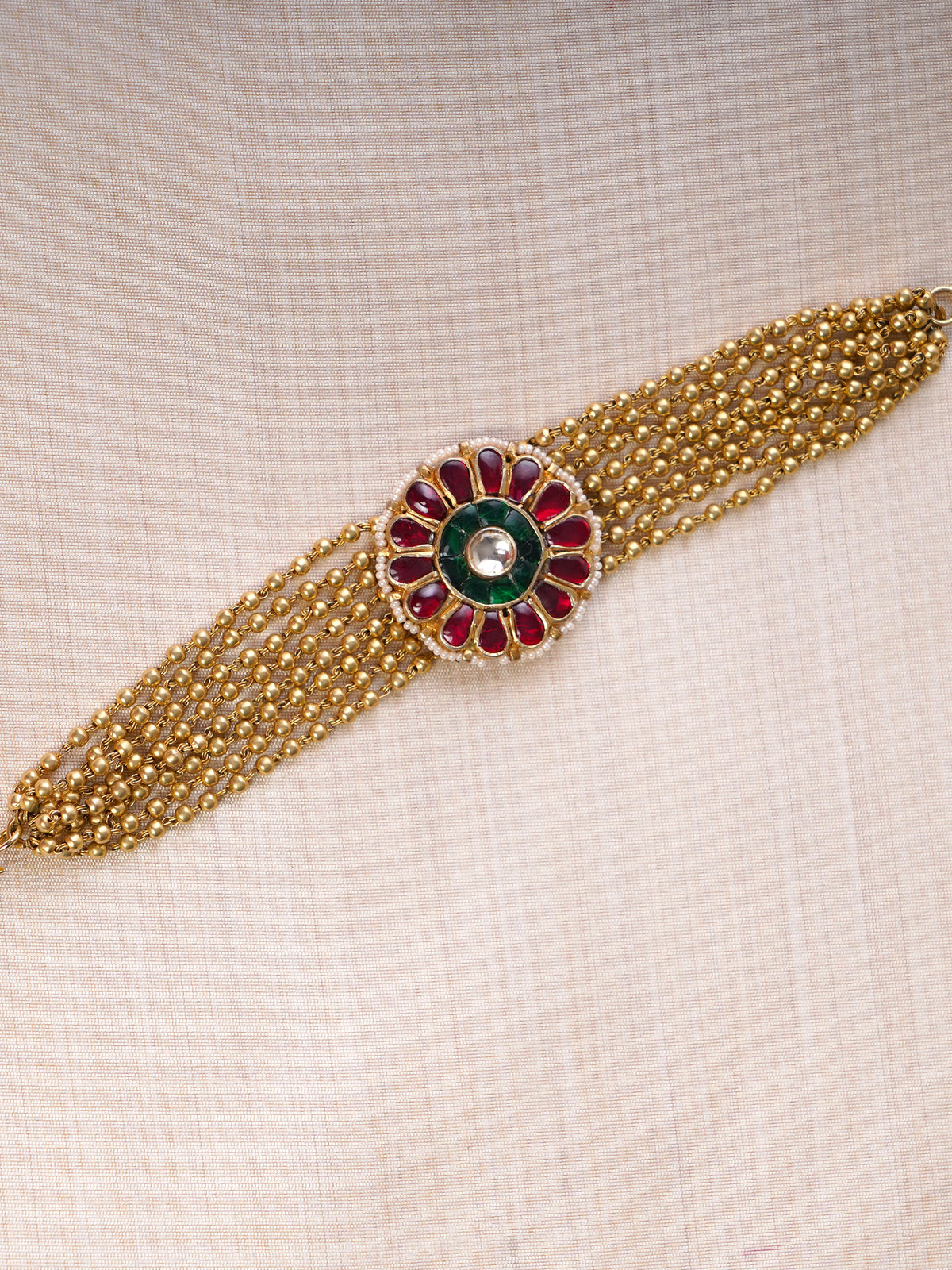 Samragni red and green floral kundan bead bracelet styled on the wrist