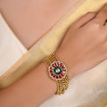 Samraagni red and green floral kundan bead bracelet shown flat with multi-strand gold-tone beads