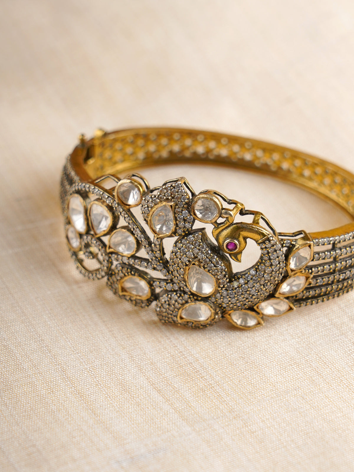 Sitaratna gold-plated peacock moissanite statement bracelet styled on wrist