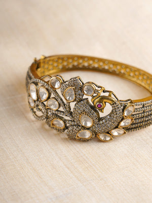 Sitaratna gold-plated peacock moissanite statement bracelet styled on wrist