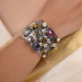 Sitamahor sculpted floral gemstone fusion cuff with wide silver tone base gold flowers and purple faceted stones