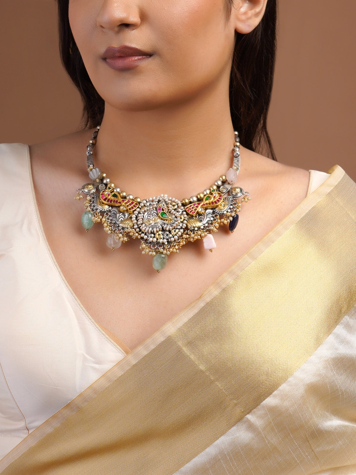 Close view of Sitamahor peacock pearl fusion necklace with silver gold motifs ruby green accents and pearl clusters