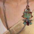 Sitamahor Navrangi enamel panel fusion long necklace styled with ivory saree and multicolour mixed-metal detailing