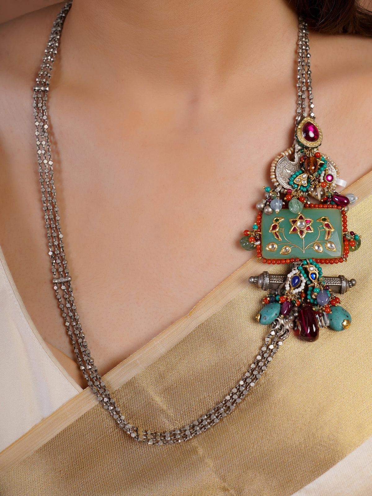 Sitamohur Navrangi enamel panel fusion long necklace styled with ivory saree and multicolour mixed-metal detailing