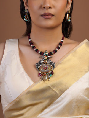 Close view of Sitamohur fusion pendant necklace with maroon black cord bird motifs pearl edging and multicolour stone drops