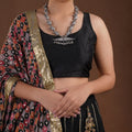 Sitavan engraved bead tribal oxidized necklace styled on model with black blouse and horizontal silver-tone pendant