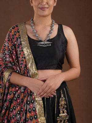 Sitavan engraved bead tribal oxidized necklace styled on model with black blouse and horizontal silver-tone pendant