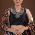 Sitavan layered oxidized silver statement necklace with multiple bead strands, engraved leaf fringe and geometric centre pendant