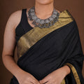 Sitavan Ganesha panel ghungroo oxidized collar necklace close-up with embossed silver-tone plaques and layered tassel fringe