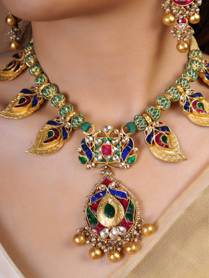 Samragni multicolour kundan and meenakari necklace set styled with matching long earrings and ivory gold saree