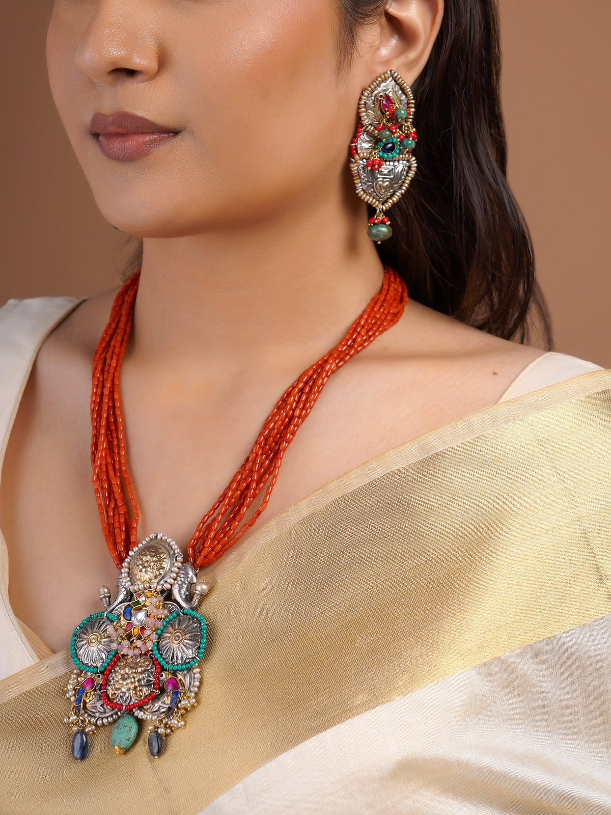 Sitamohur coral bead fusion statement earring close-up with oxidized silver-tone relief, turquoise accents and red bead detailing