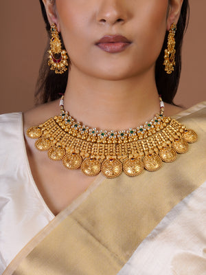 Samraagni matching antique gold statement earring close-up with green ruby kundan-style accents and engraved hanging details