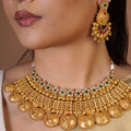 Samragni heritage kasu antique gold necklace set with engraved temple-style drops, green ruby accents and matching statement earrings