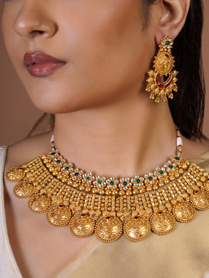 Samraagni heritage kasu antique gold necklace set with engraved temple-style drops, green ruby accents and matching statement earrings