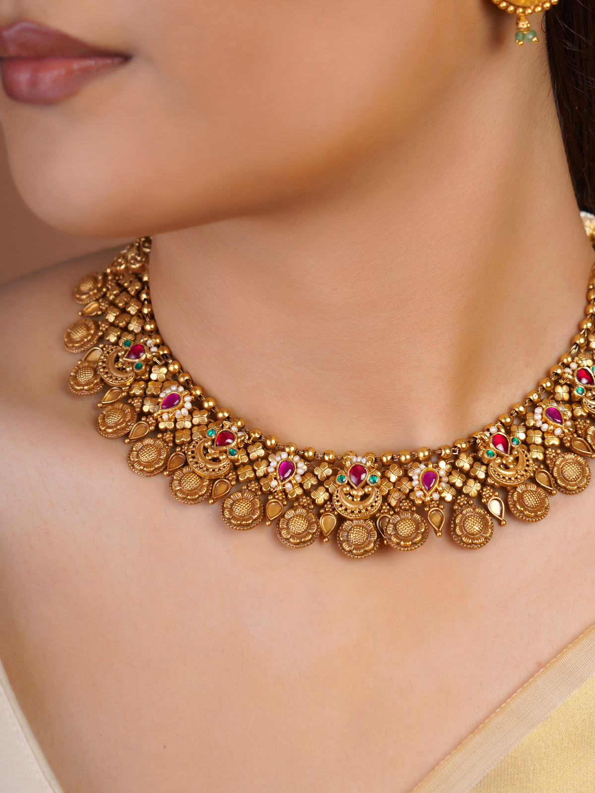 Samraagni antique gold temple collar necklace with ruby pink green stone accents and layered embossed heritage motifs