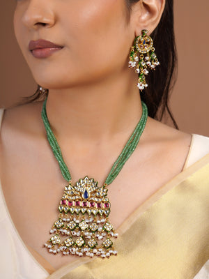 Samragni matching peacock kundan statement earring close-up with green enamel-style details, blue ruby stones and pearl cluster drops
