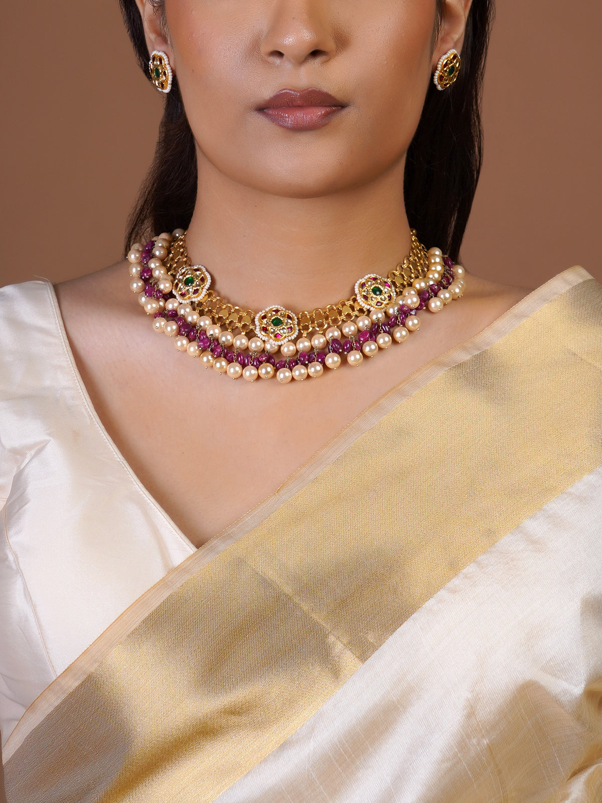 Samragni round kundan stud earring close-up with green centre, ruby accents and pearl border