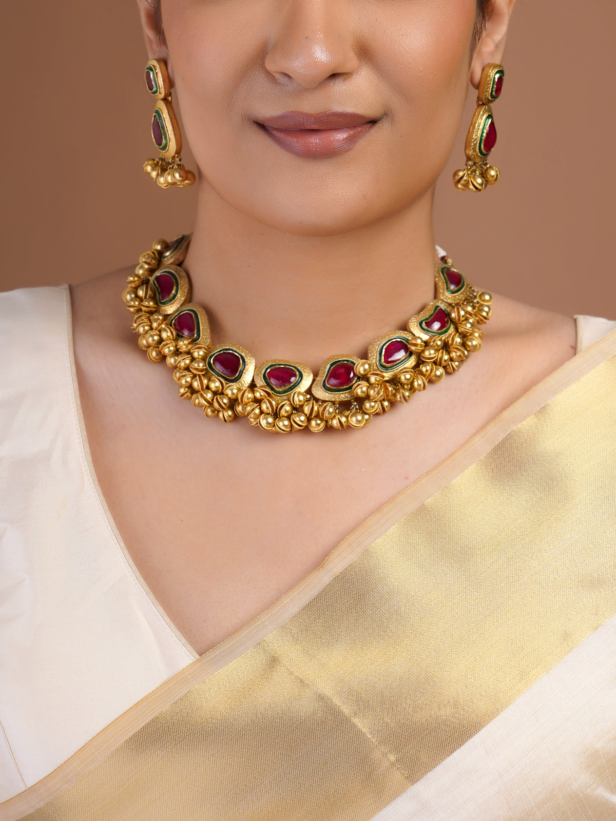 Samraagni antique gold ruby green statement earring close-up with rectangular and teardrop stones and clustered gold bead fringe
