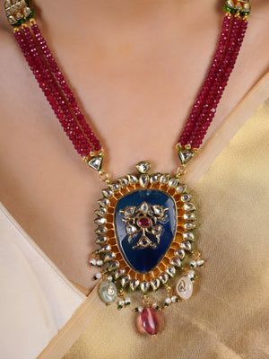 Samraagni ruby bead necklace pendant close-up with deep blue centre, kundan-style white stone halo and gemstone drops