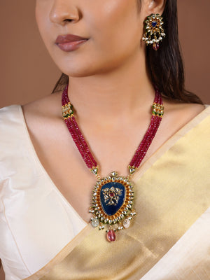 Samragni blue kundan statement earring close-up with floral white stone frame, pearl clusters and ruby drop