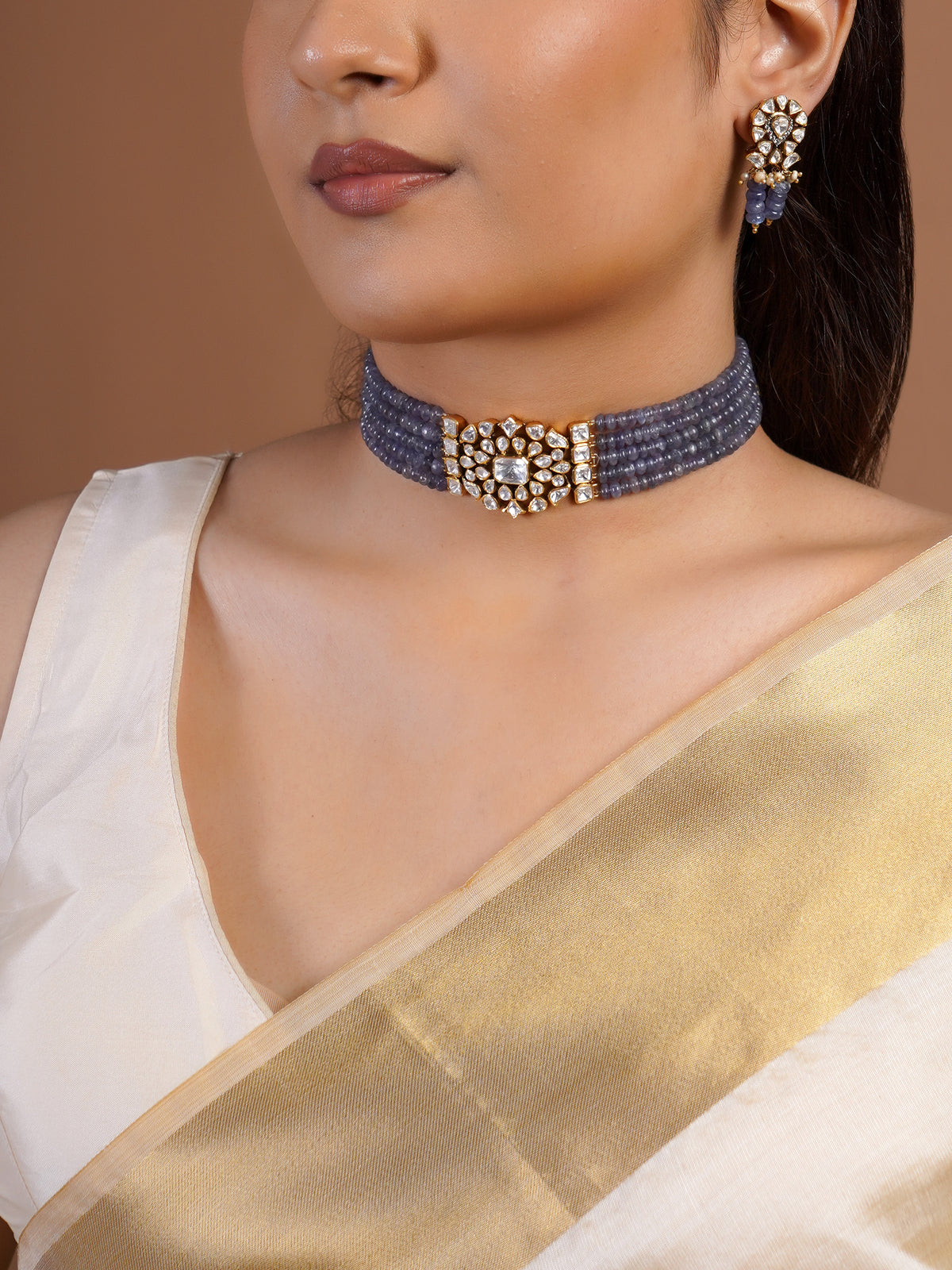 Samraagni polki kundan floral earring close-up with clear white stones, pearl accents and lavender bead drops