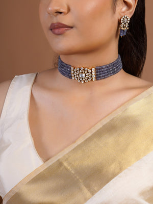 Samragni polki kundan floral earring close-up with clear white stones, pearl accents and lavender bead drops