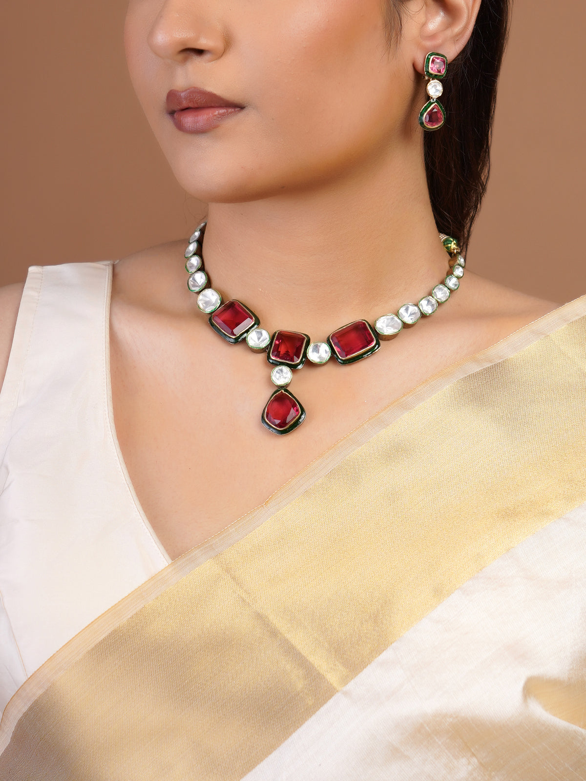 Samragni ruby red and white kundan necklace set with green enamel-style borders, central drop and matching earrings