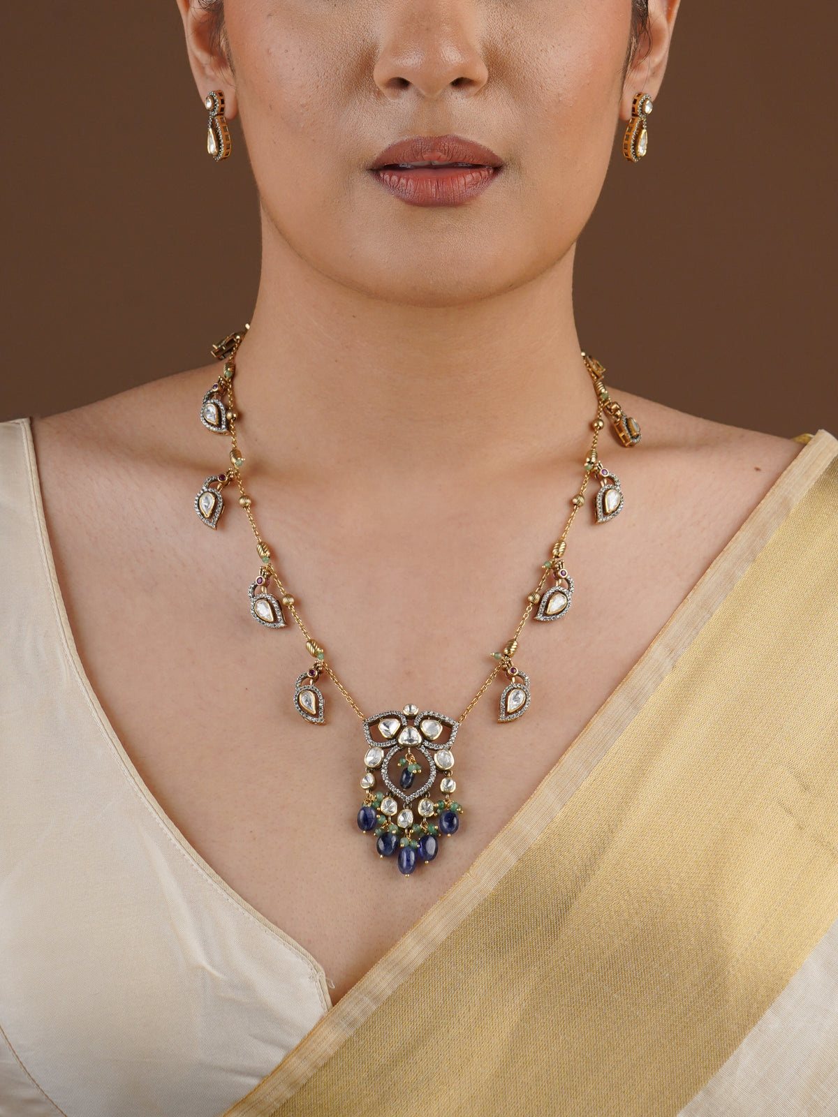 SITA RATNA matching teardrop moissanite earring close-up