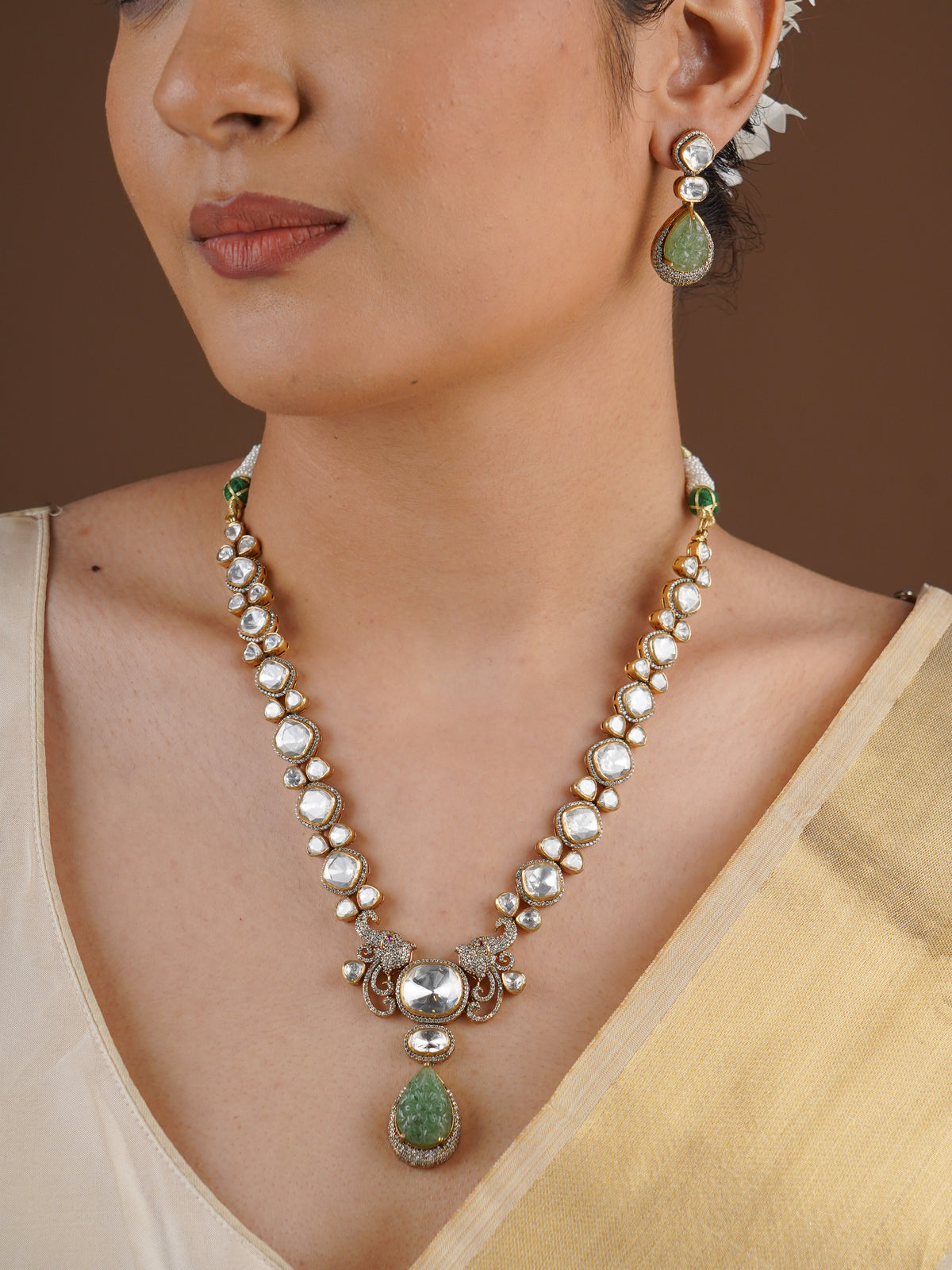 SITA RATNA matching green carved teardrop moissanite earring close-up