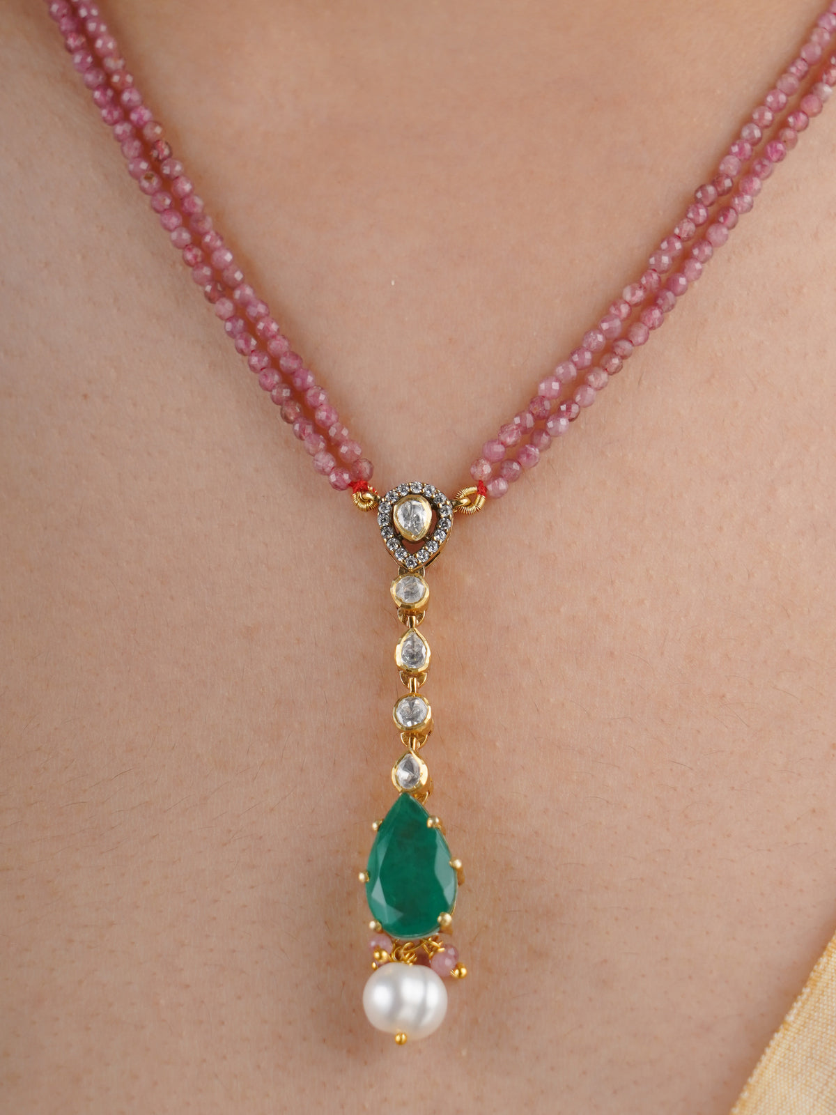 SITA RATNA matching green teardrop moissanite and pearl drop earring close-up