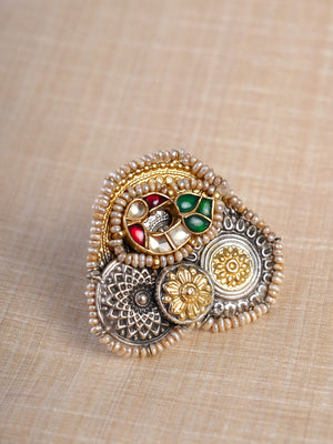Sitamahor navrangi pearl fusion statement ring shown on hand with layered silver-gold floral medallions and red green details