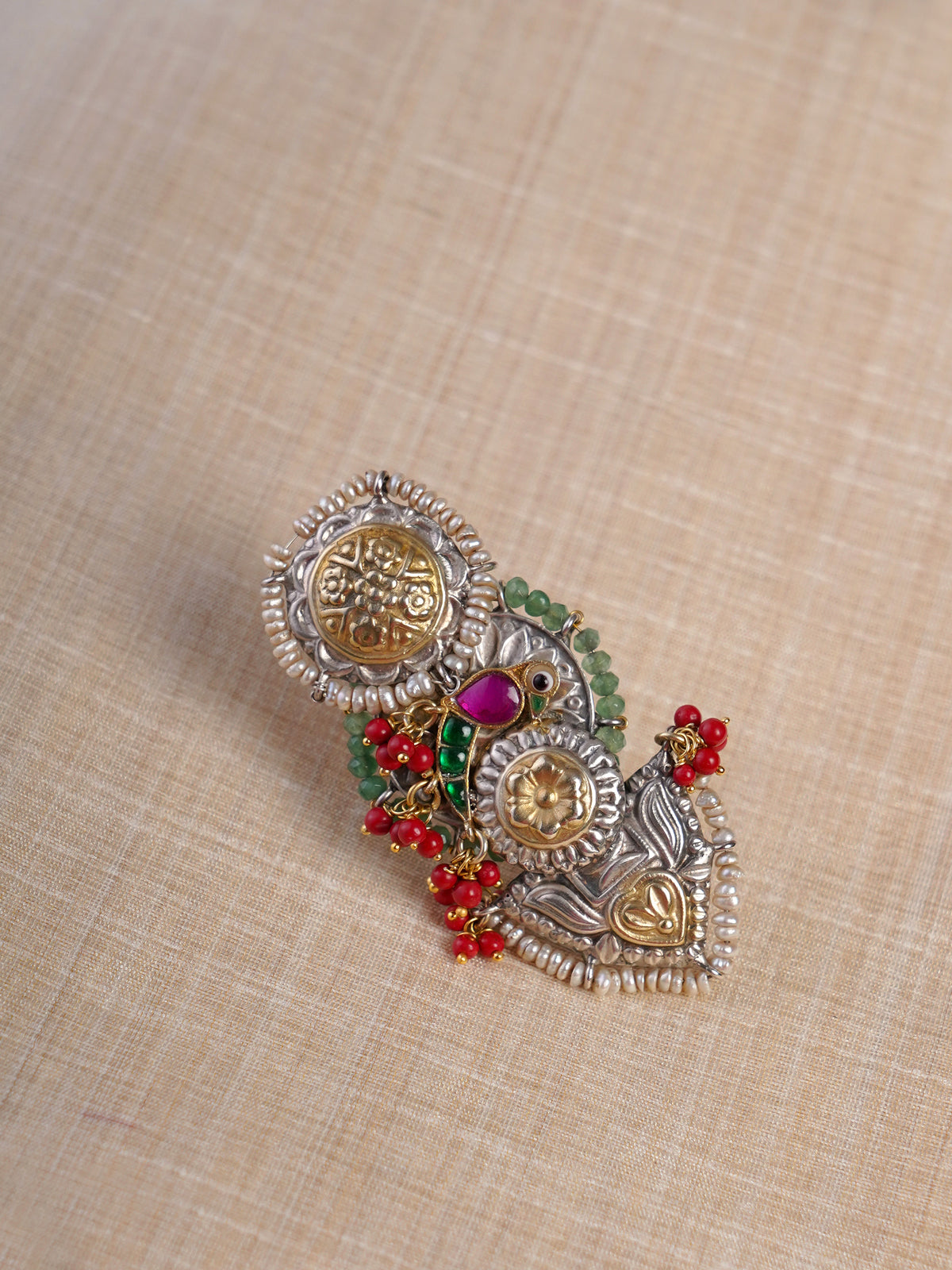 Sitamahor peacock coral green fusion statement ring shown on hand with elongated dual-tone floral and bird motif design