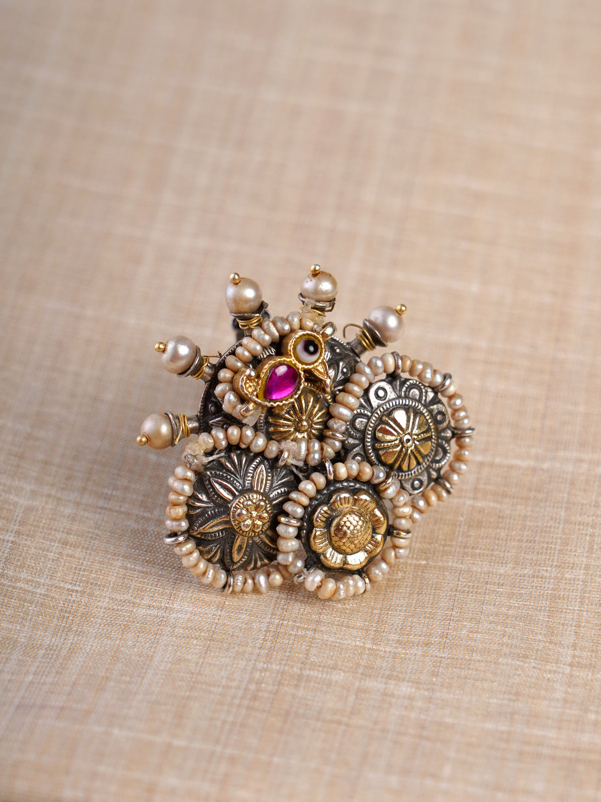 Sitamahor pearl peacock medallion dual-tone fusion statement ring shown on hand with layered silver-gold motifs and magenta accent