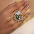 Sitamahor peacock fan dual-tone fusion statement ring with green enamel-style accents, white kundan-style stones, pearls and mixed metal motifs